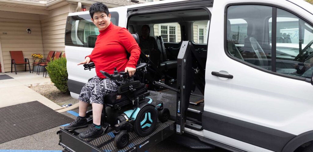 Rose House Resident being placed into one of their Vans to be taken on an activity.