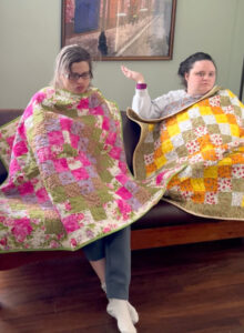Rose House residents Felicia and Diana with quilts donated by the Garden State Quilters Guild of Madison, NJ