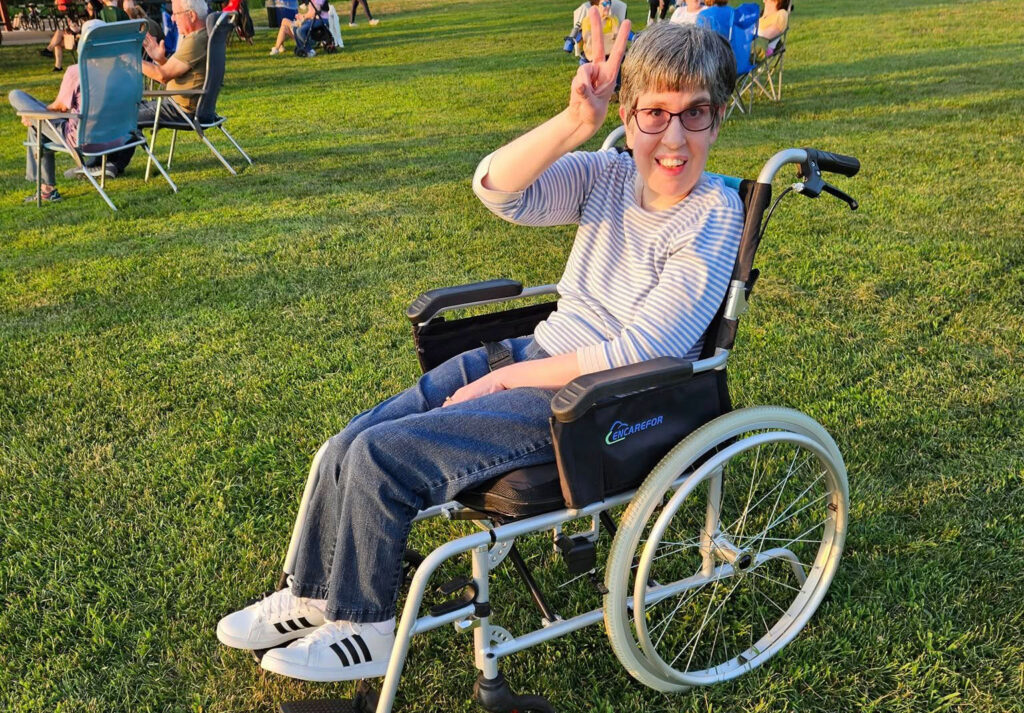 Laura, a resident at Rose House's Parsippany Group Home, enjoying a music festival at the Montville Community Park