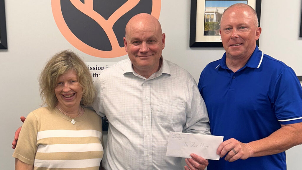 Knights of Columbus #6904 Co-chair Mike Mulligan (pictured center) presents a donation to Rose House CEO Tom Mitchell and Jenny, an Independent Living Program resident.